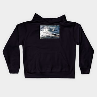 Seagulls flying over the waves, Seahouses, Northumberland, UK Kids Hoodie